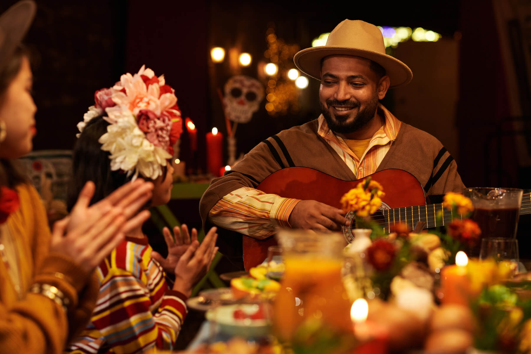 man playing guitar at dinner party 2023 11 27 05 02 16 utc.jpg