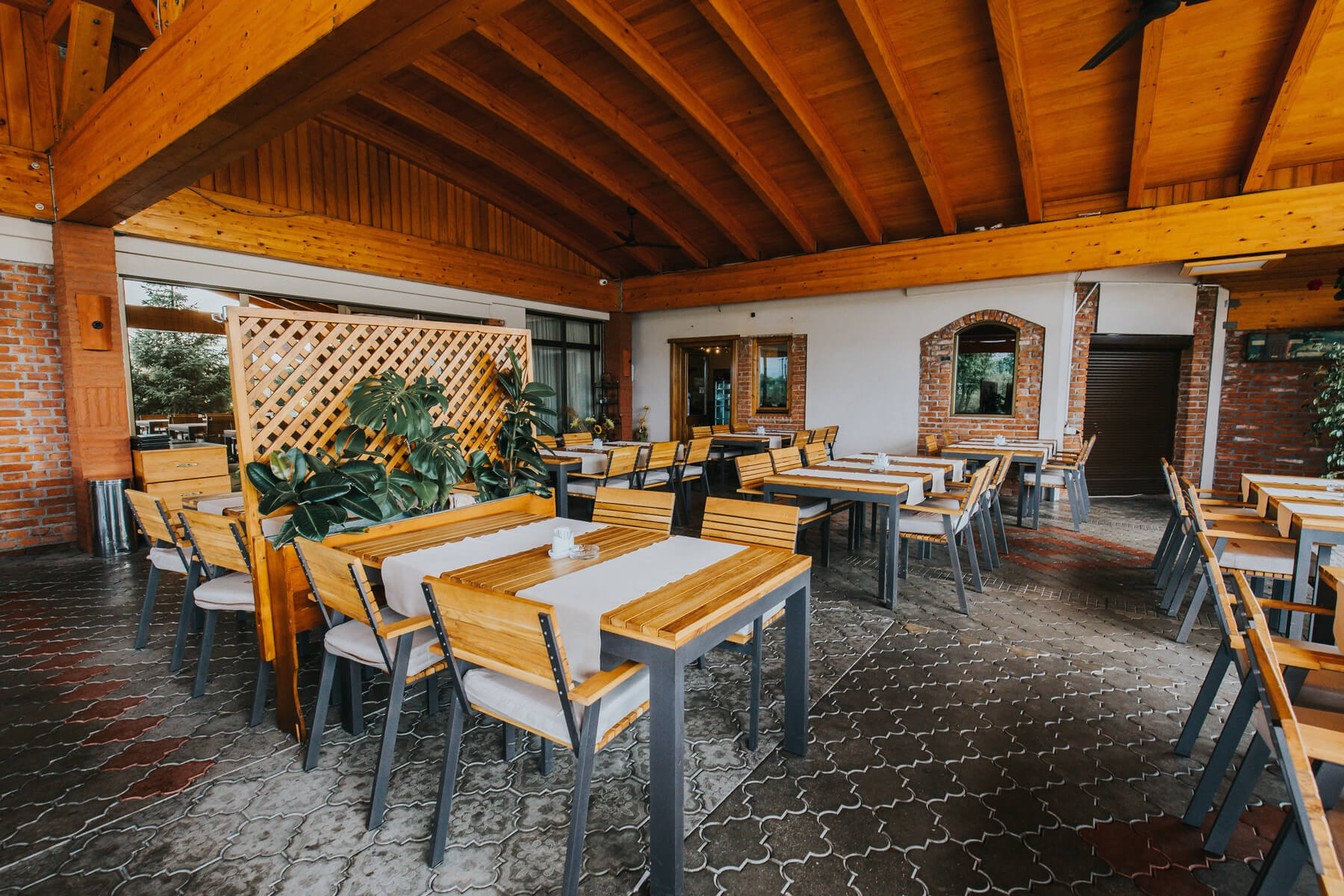 outdoor restaurant with wooden chairs and tables 2023 11 27 04 53 33 utc.jpeg