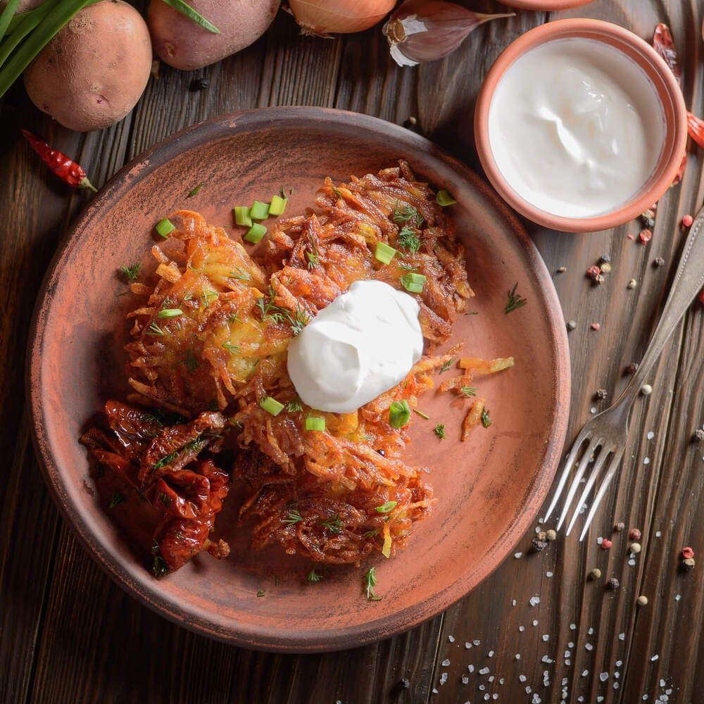 top view at flat lay potato pancakes in clay dish 2023 11 27 05 15 56 utc.jpg